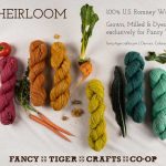Fancy Tiger Crafts Pom Pom magazine ad featuring yarns in various colors next to a variety of vegetables.