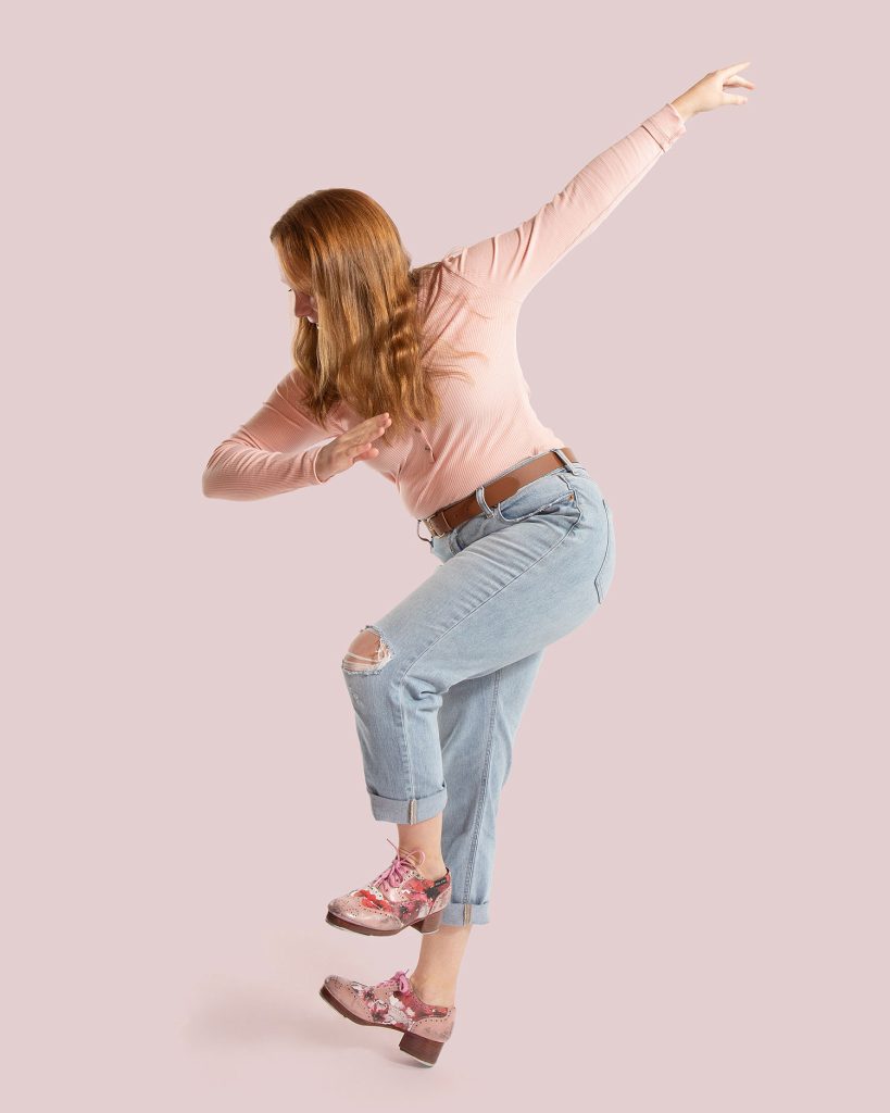 Dance Company Photoshoot with Rocky Mountain Rhythm showing a dancer in pink doing a heel stand.