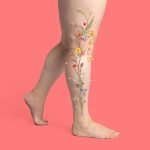 Retouching services for Metro Vein Center, featuring wildflowers and plants stuck to the side of a woman's leg on a coral background.