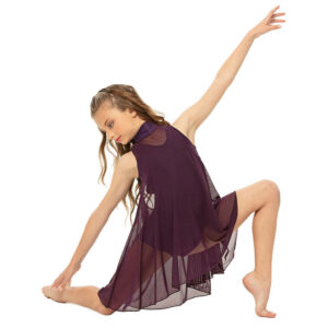 Lyrical dancer posed in a kneeling position on the floor, reaching back and looking downward.
