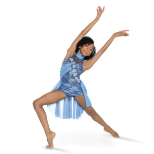 Lyrical dancer posed in a forced arch lunge with arms outstretched and reaching upward.