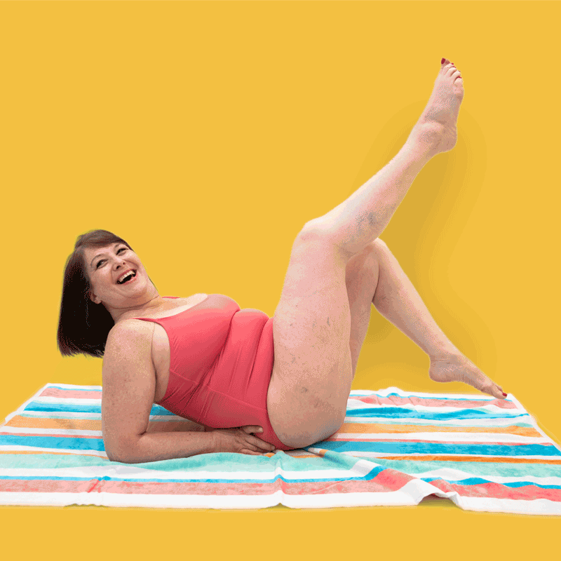 Stop motion gif of woman kicking legs and laughing in bathing suit.