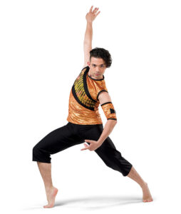 Contemporary dancer posed in a lunge with one arm curved downward and one straight reaching up and back.