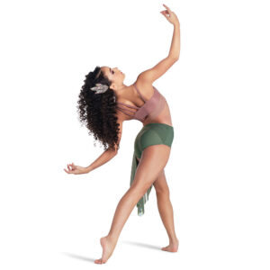 Contemporary dancer posed facing away from camera with one foot pointed behind and arms curved in an arch.