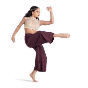 Contemporary dancer posed in a front attitude and forced arch, one arm bent and lifted.