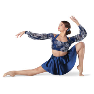Lyrical dancer posed in a deep lunge on the ball of one foot and the other pointed. Arms are gracefully reaching outward.