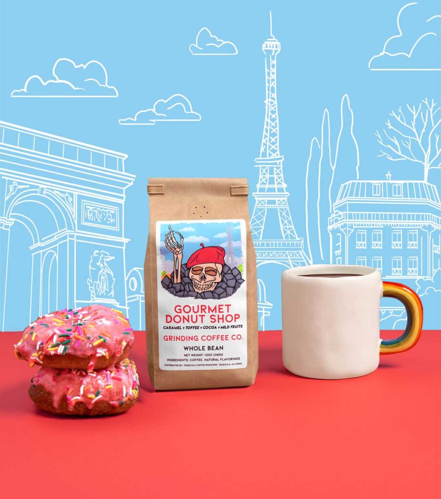 Grinding Coffee Co bag of Gourmet Donut Shop, donuts and coffee cup, with Paris illustrated on the wall behind.