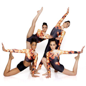 Group of jazz dancers posed dynamically with arms and legs outstretched.