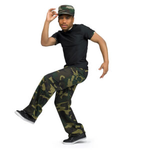 Hip hop dancer posed with one leg lifted and one on hat while the other reaches behind.