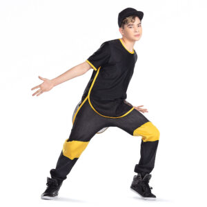 Hip hop dancer posed in a lunge pressed forward and arms bent out to sides as though asking "what".