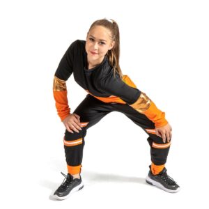 Hip hop dancer posed with bent knees and hands on knees leaning to the side.