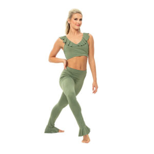 Jazz dancer posed in a forward lunge with one hand on hip.