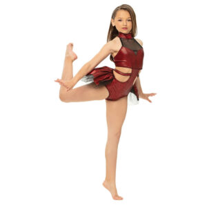 Jazz dancer posed in an attitude on elevé with hands flexed and pressing down.