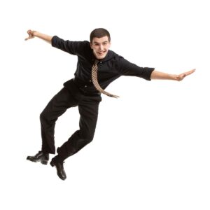 Tap dancer in the middle of a heel click with arms outstretched.