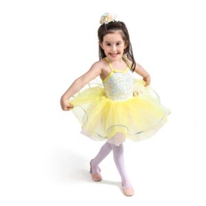 Young dancer posed in b plus with hands on the edges of their tutu holding it outward.