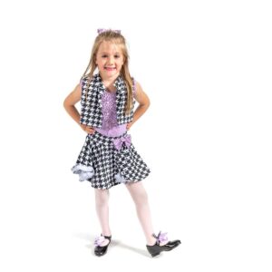 Young dancer posed with foot flexed to the side and hands on hips.