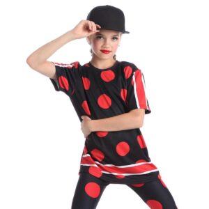 Young hip hop dancer posed with one hand across their belly and the other holding onto their hat.