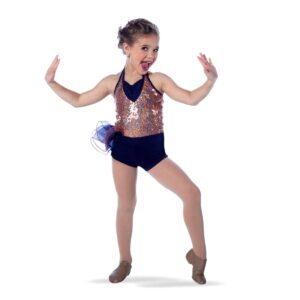 Young dancer posed with one foot popped and hands flexed to their sides.