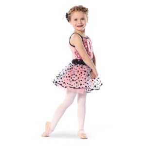 Young dancer posed with hands clasped and foot pointed behind as they twist to the side.