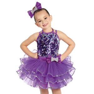 child ballet dance pose in purple tutu