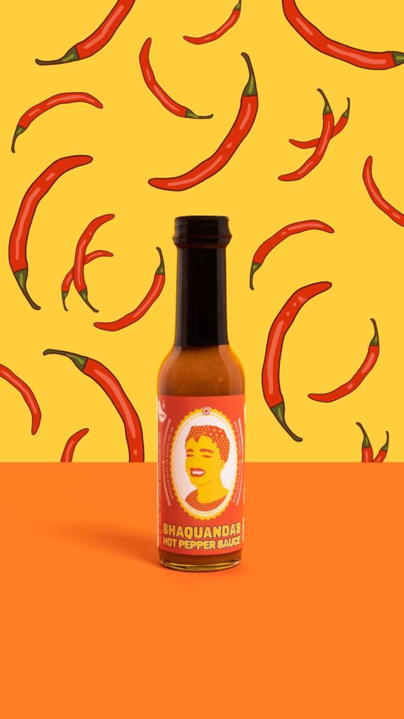 E-commerce product shot of Shaquanda's hot sauce with red pepper pattern illustrated behind it.