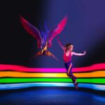Dance poster of tap dancer and phoenix with rainbow lights background.