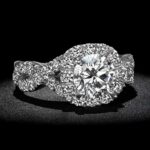 retouched diamond ring photograph on black background with spotlight