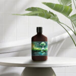 Photo composite of lotion bottle from Melt on a modern table next to a freestanding bathtub.