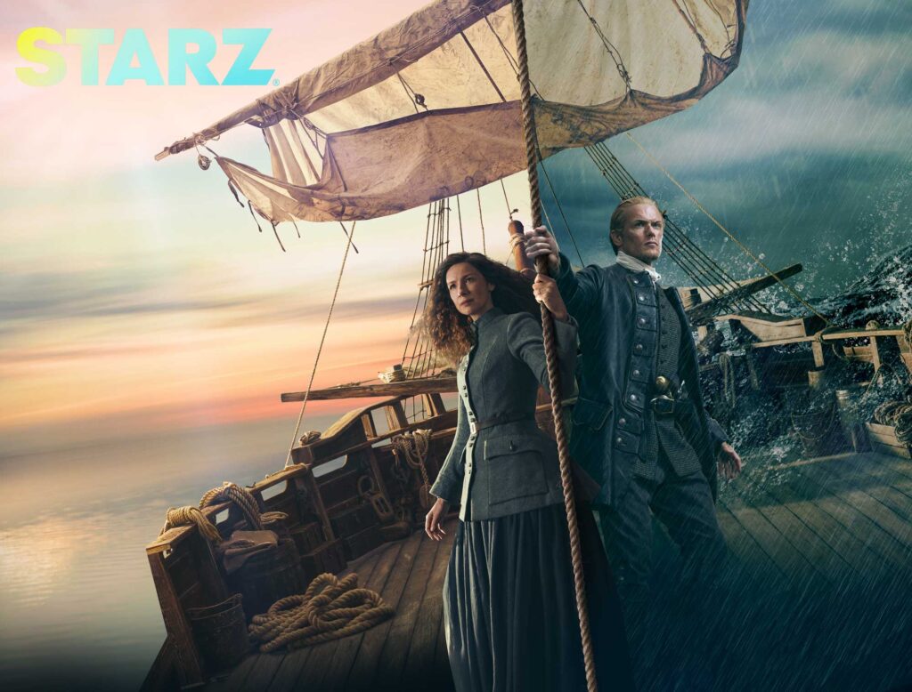 Billboard featuring image of Outlander stars from Starz