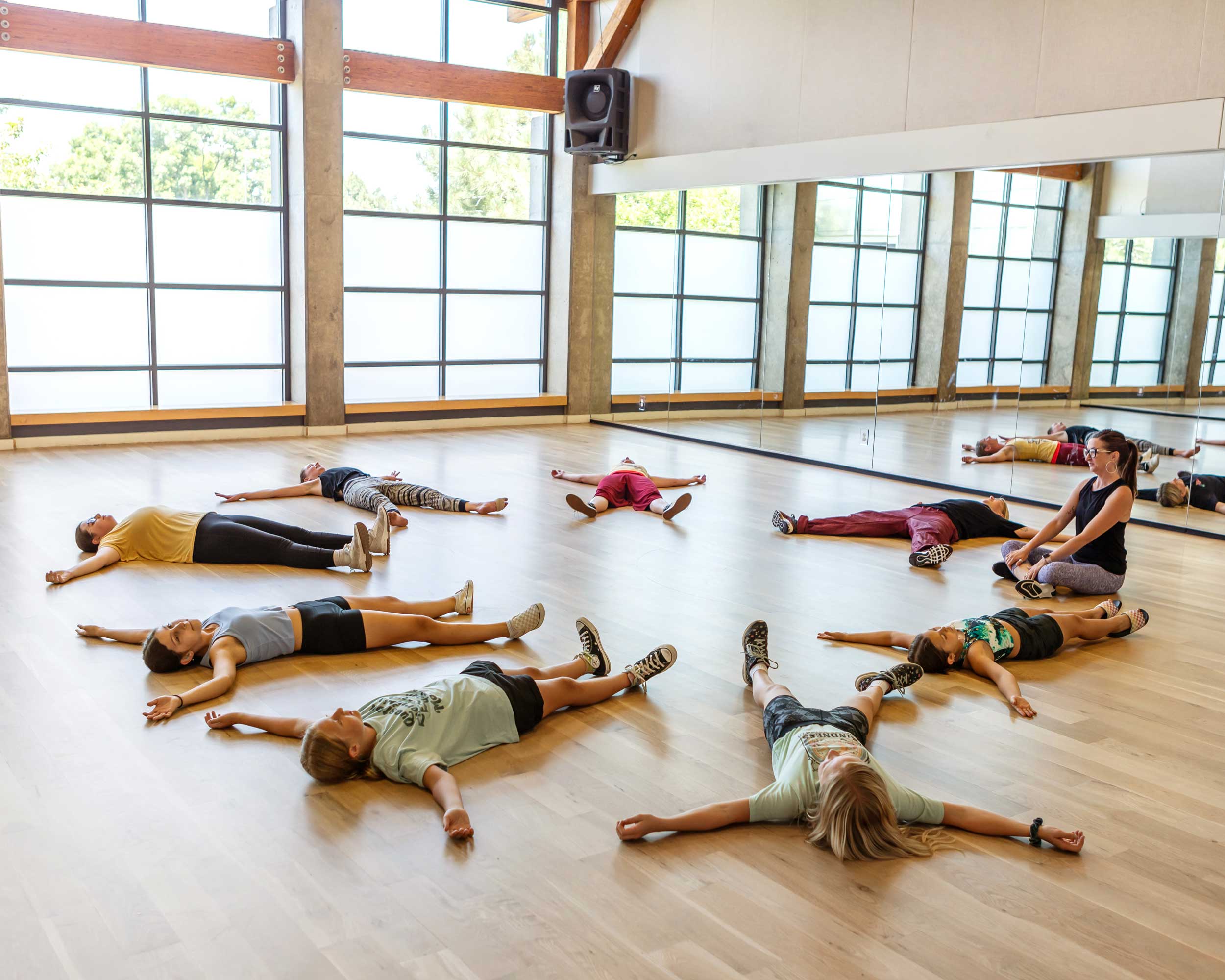 Dancers laying on the technical floor at Feel the Beat for brand photography, showing the effects of the tech.