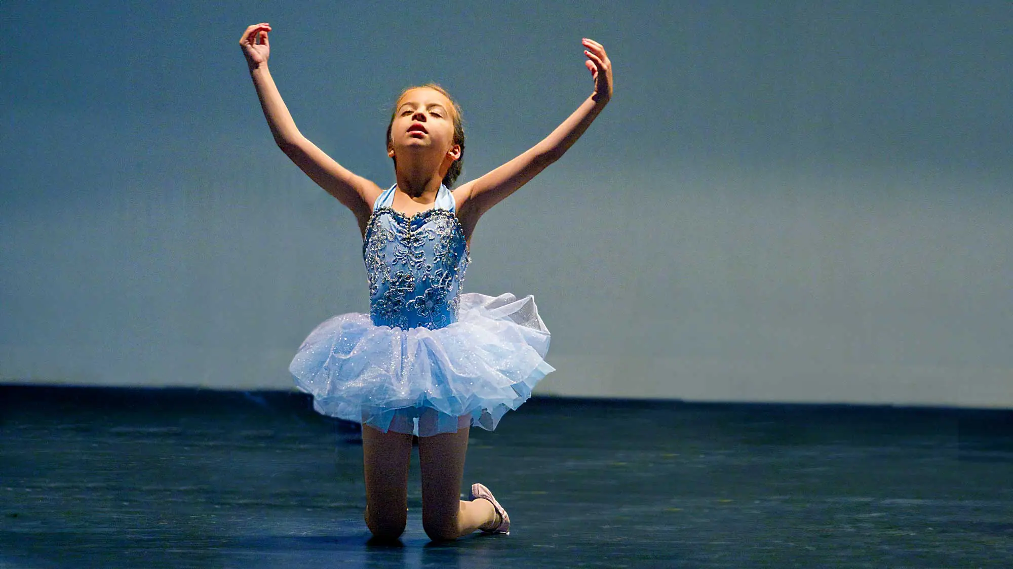 Young dancer on stage photographed at dress rehearsal