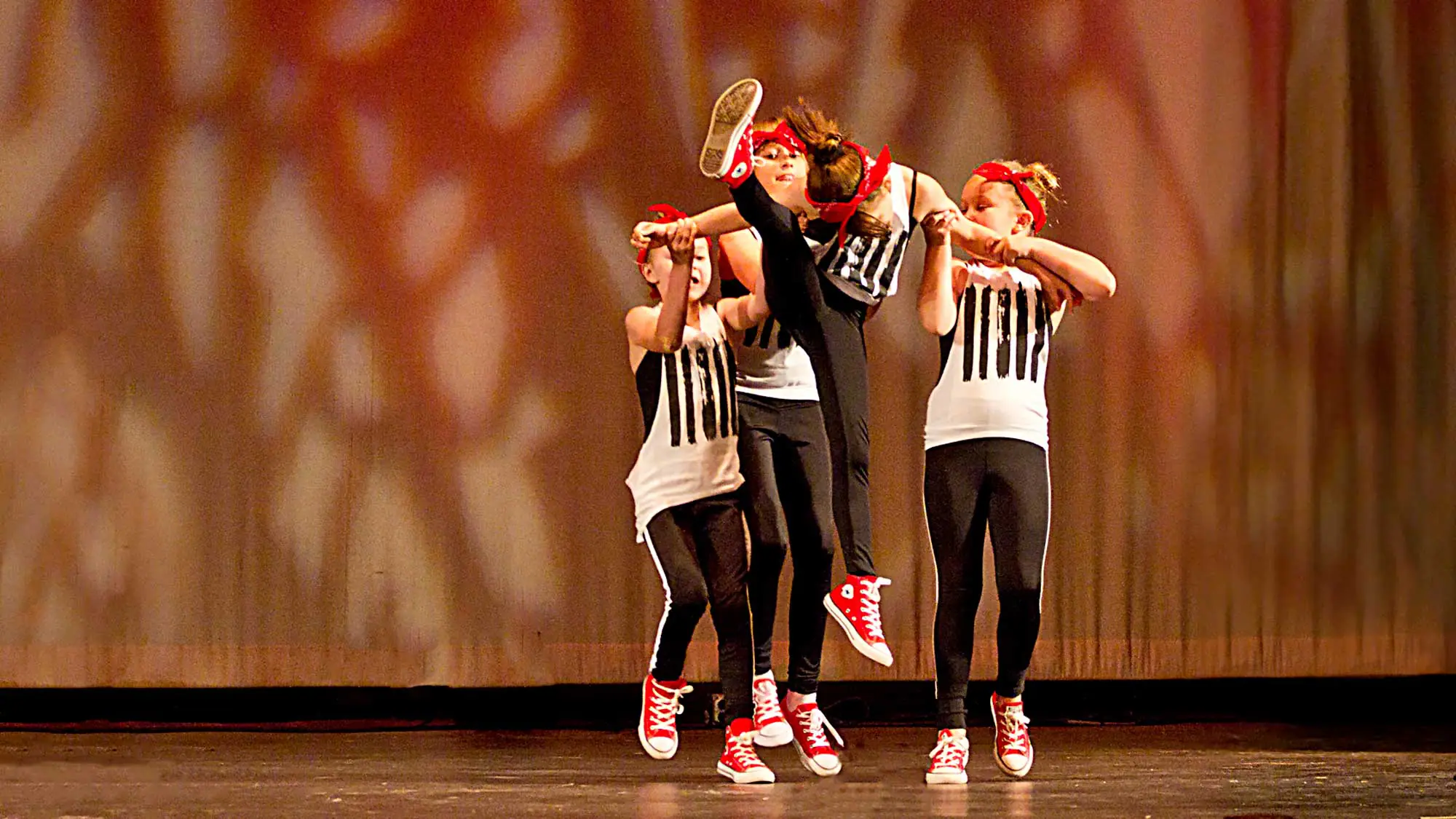 Young dancers on stage photographed at dress rehearsal