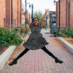 Dancer doing star jump in downtown Longmont