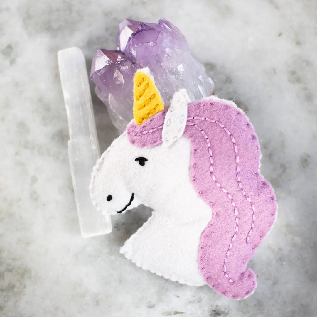 Felt kit of unicorn with crystals on a marble surface