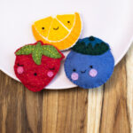 Felt sewing kits of an orange, strawberry and blueberry