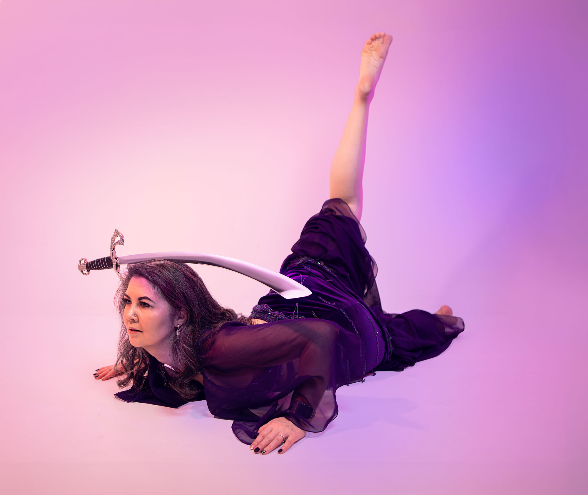 Belly dancer posed with sword on head