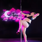 Pole dancer at Selenite Studio with head tossed back in an arch