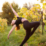 Dancer in an arched passe in the middle of a vineyard