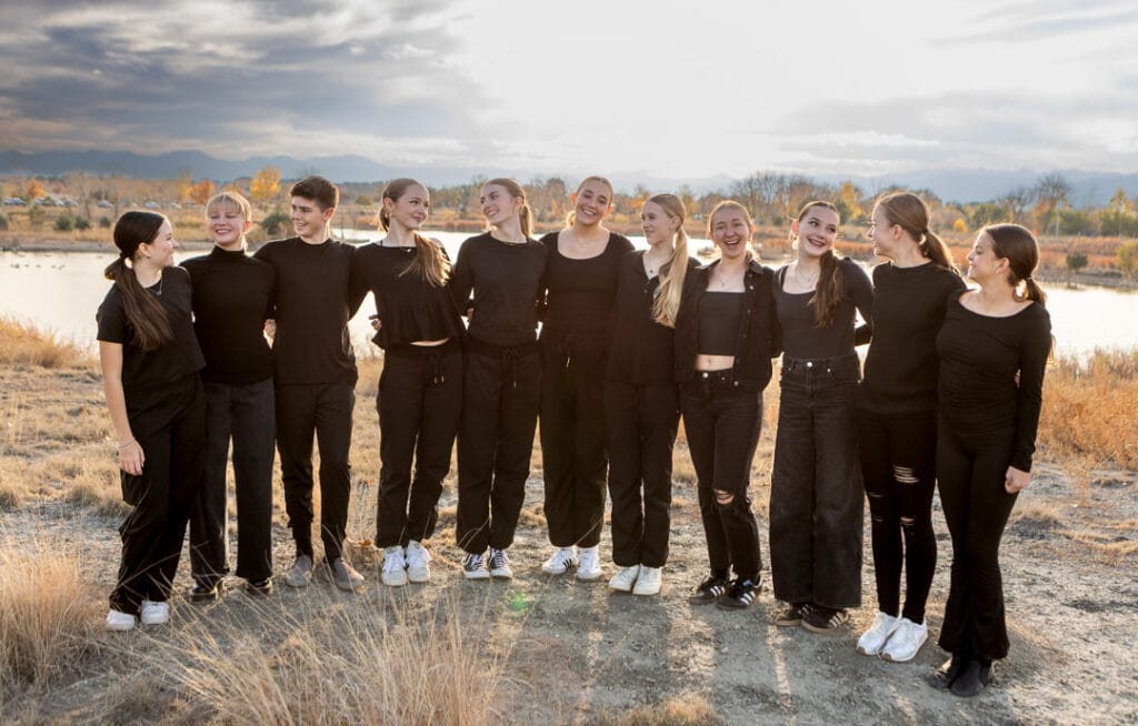 group of hip hop jazz dance company posed outdoor by the lake