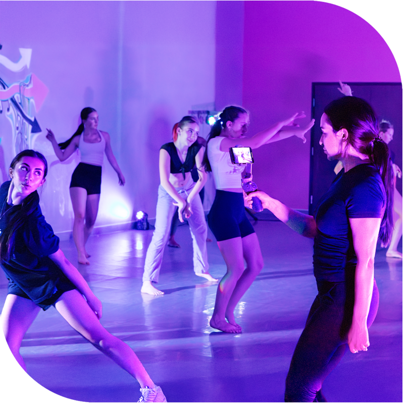 Dance teacher filming her dancers performing in class