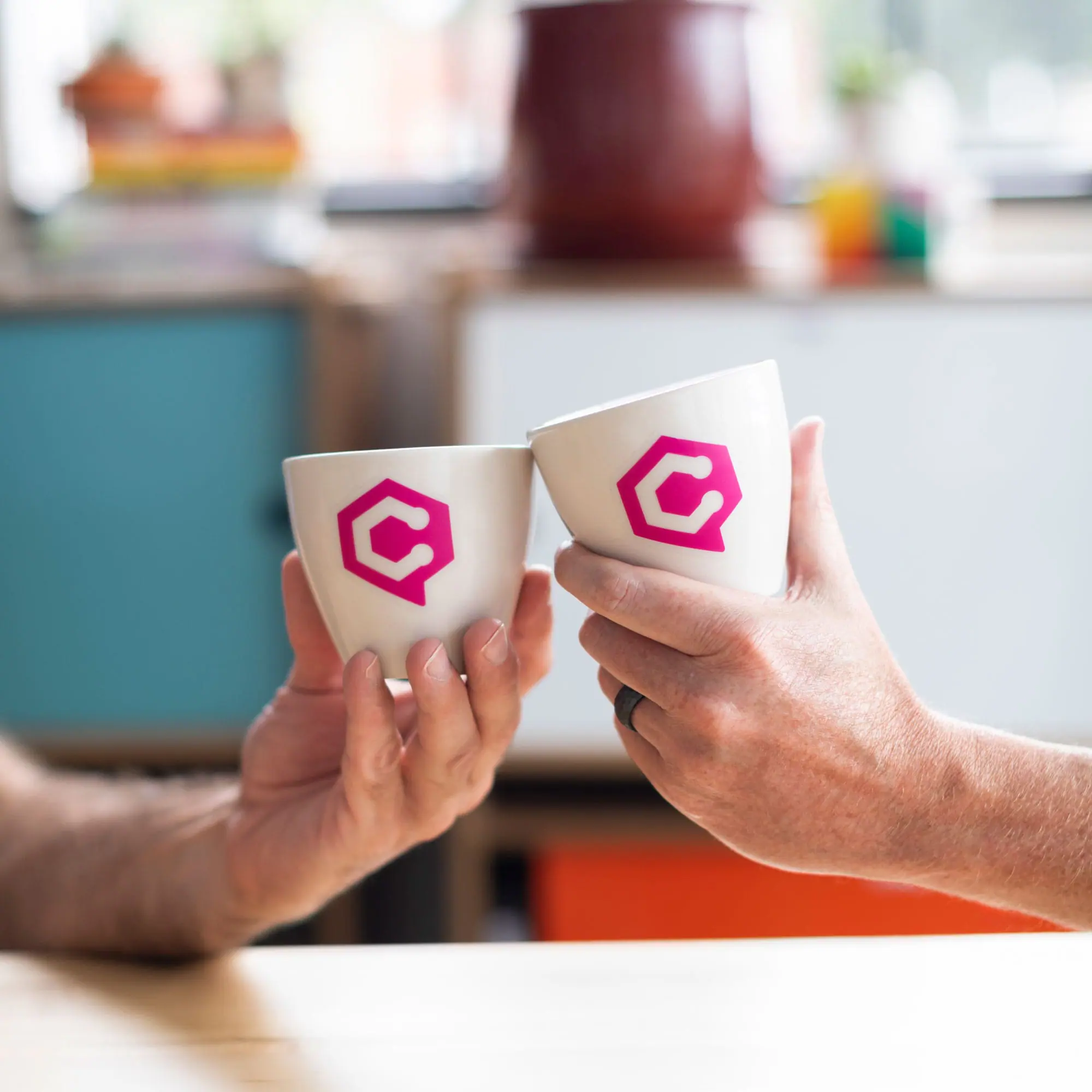 Bright ceramic mugs with Chloe branding, ideal for promotional coffee cups at Andrews Artistry.