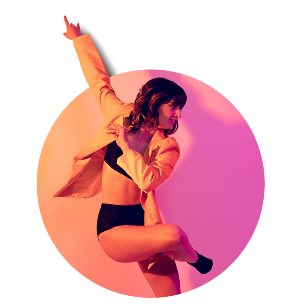 Elegant woman dancer in stylish outfit performing dynamic pose, vibrant pink and orange lighting, modern artistry.
