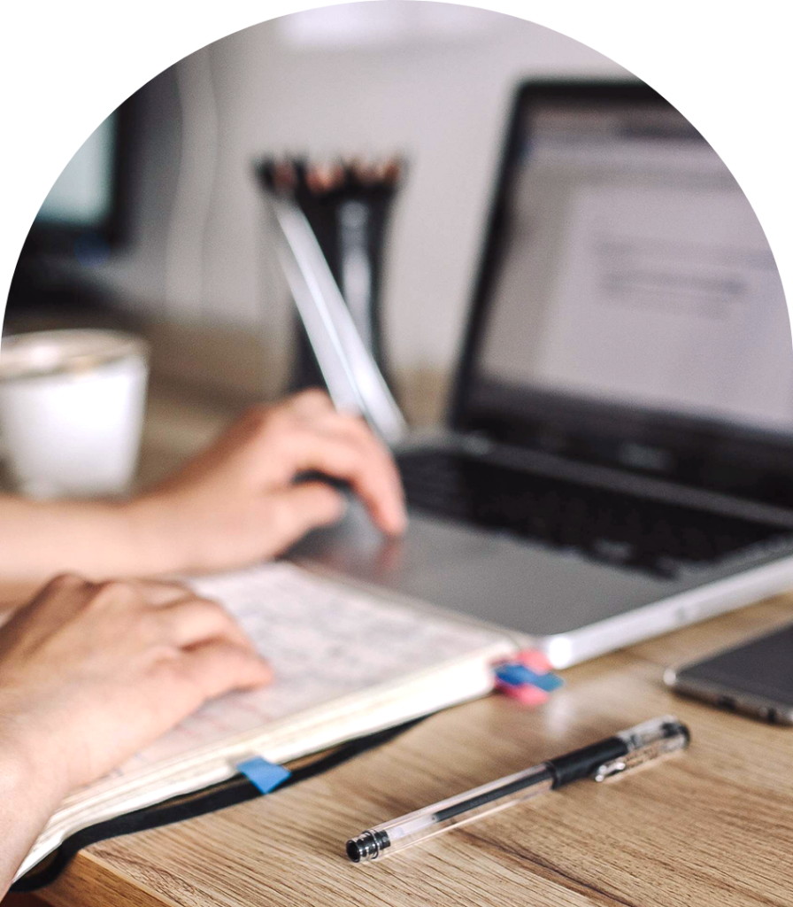 Creative digital artistry workspace with laptop and planning tools for custom art projects.