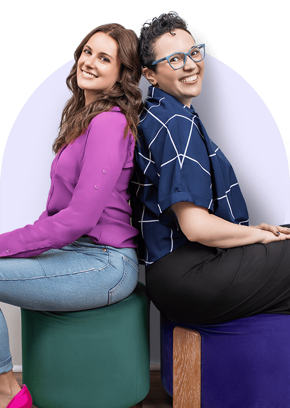 Two women seated back to back.