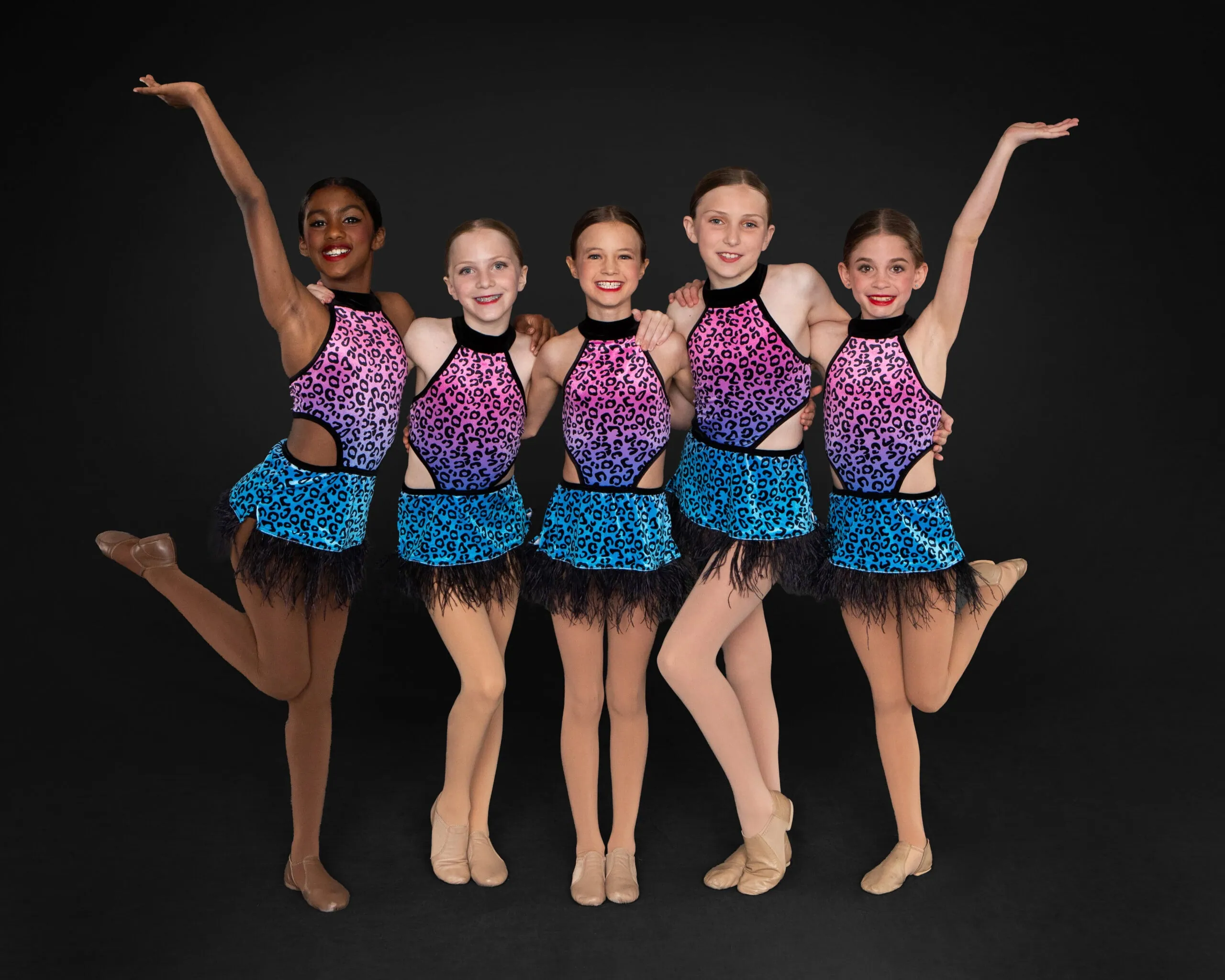 Dancers in colorful costumes posing together.