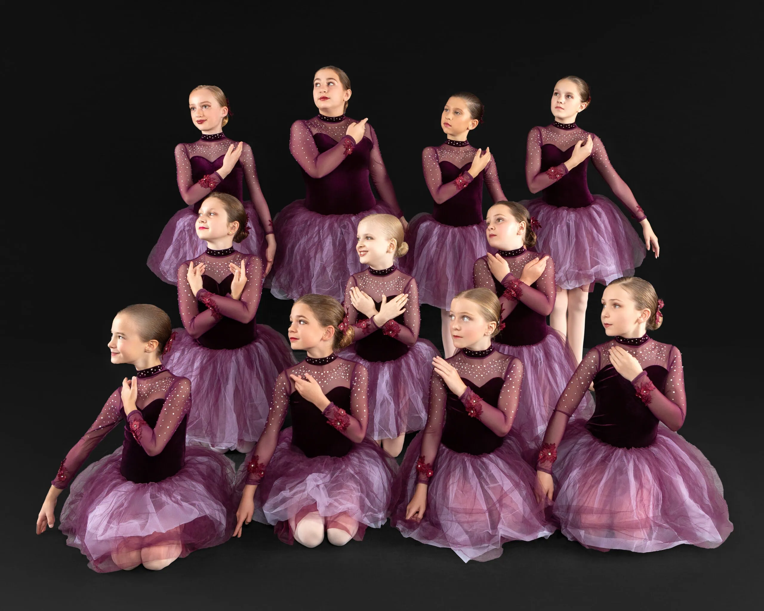 Group of dancers in purple costumes.