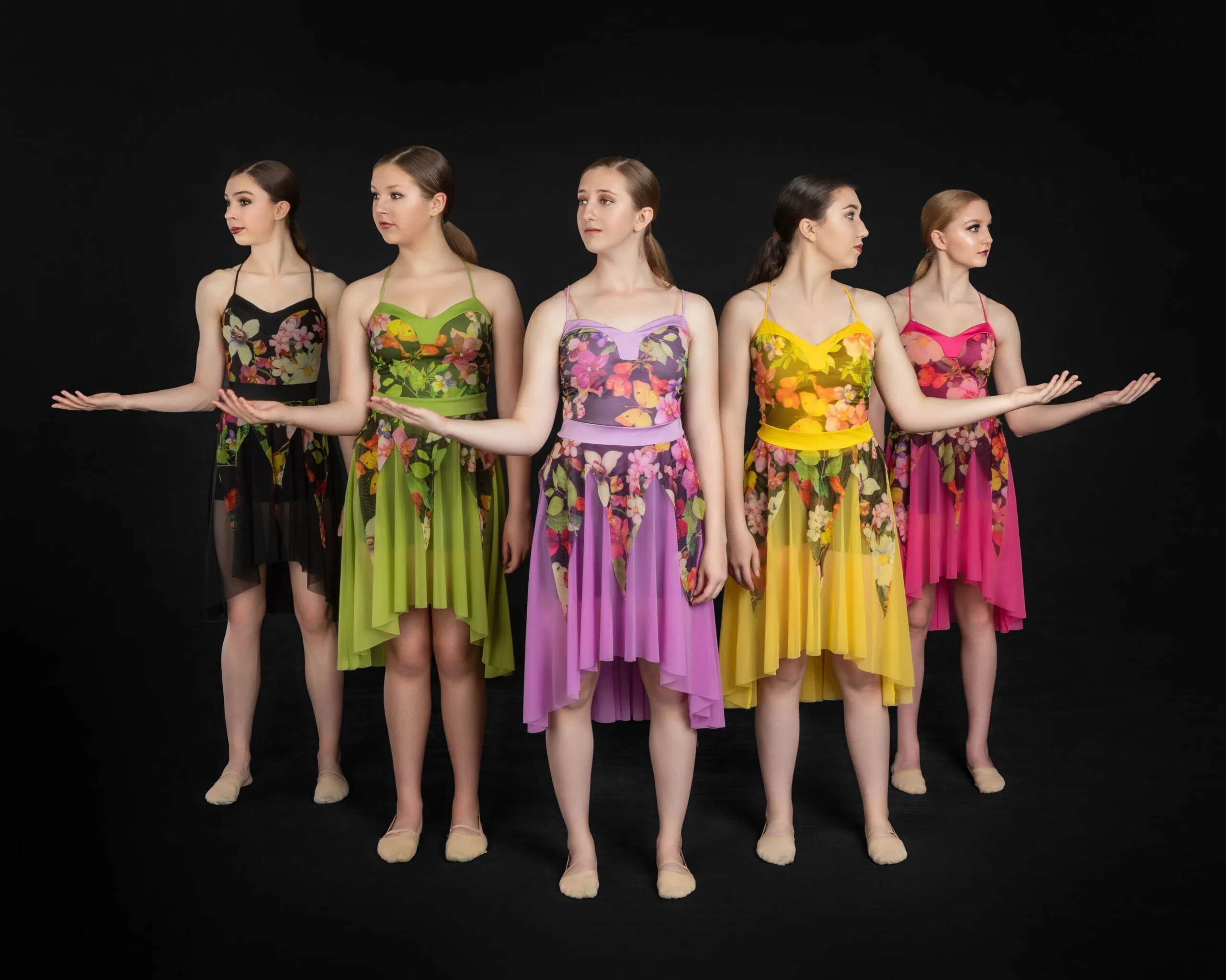 Dancers in colorful floral costumes.