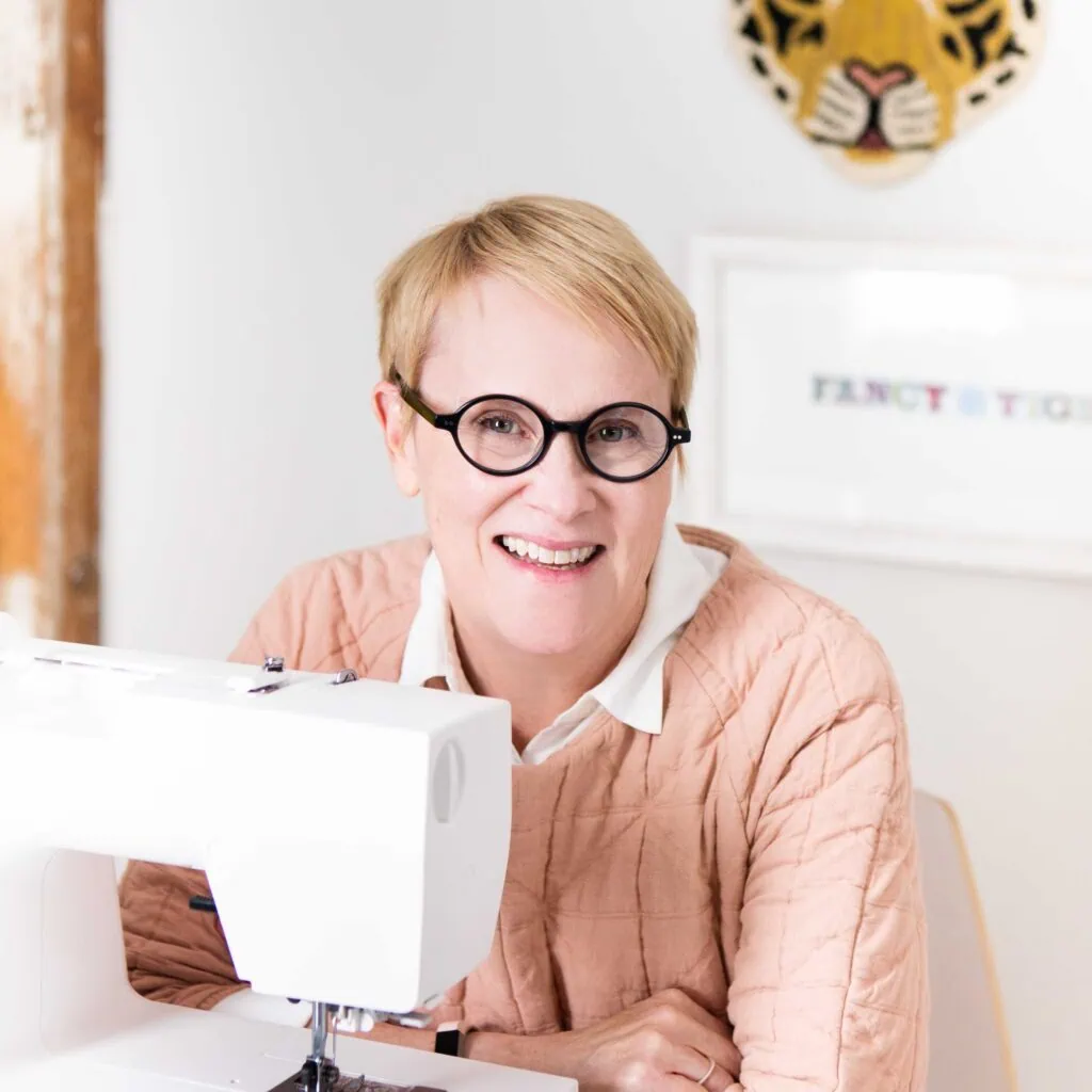 Creative quilting artist working on intricate designs with sewing machine at Andrews Artistry.