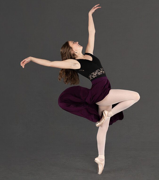 Recital photography of dancer en pointe doing an arched passe.